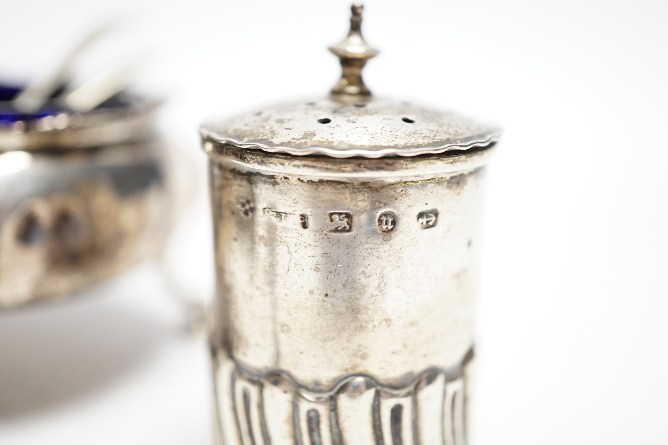 Two Georgian silver bun salts and three other silver condiments.